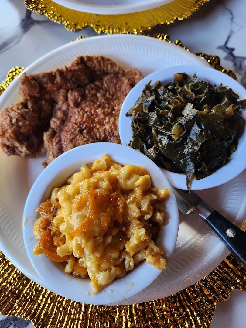 Plates of soul food on a restaurant table.